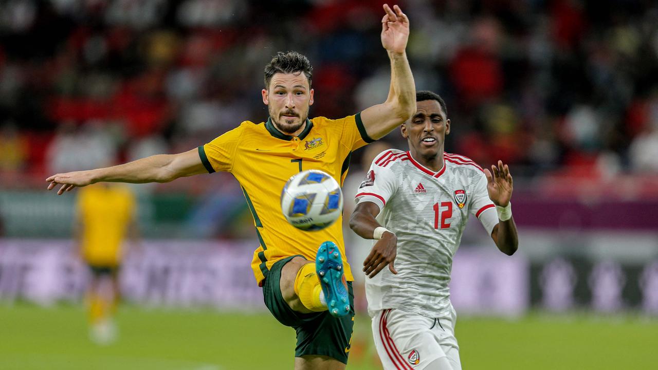 Socceroos attacker Mathew Leckie (left) gets the better of UAE defender Khalifa al-Hammadi. Picture: Mustafa ABUMUNES / AFP