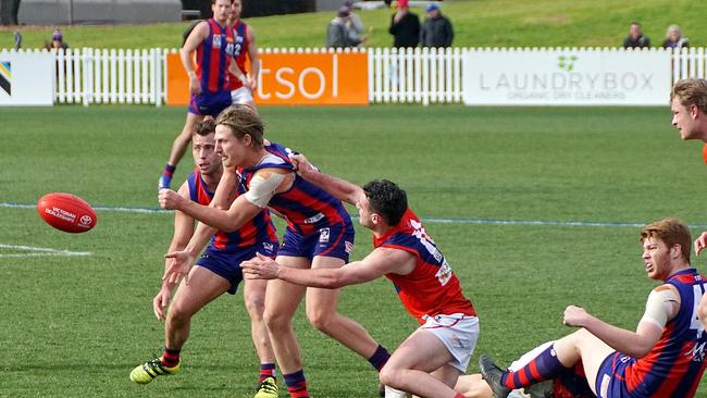 Eli Templeton shoots out a handball for Port Melbourne. Pic: Jenny Tserkezidis