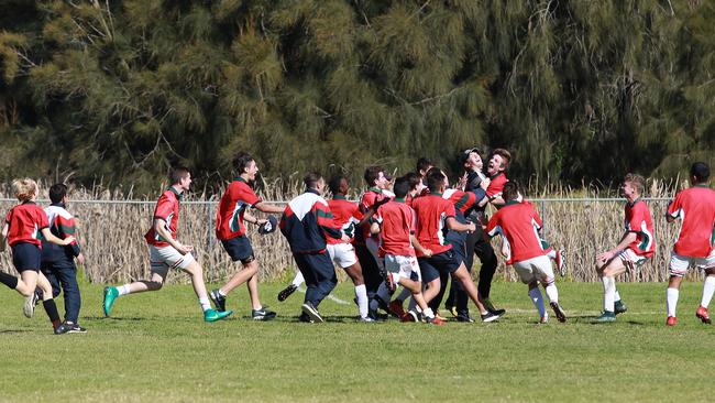 Students mob their keeper Ryan Hancock after his freak goal.