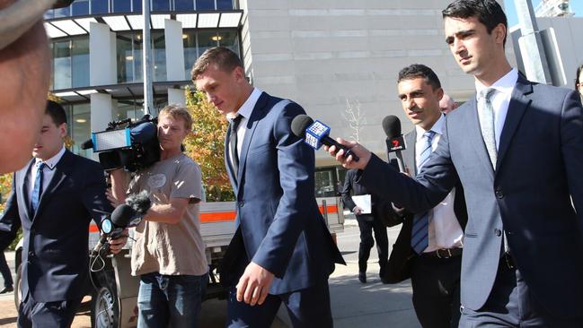 Wighton walks through the media pack after leaving court. (Kym Smith)