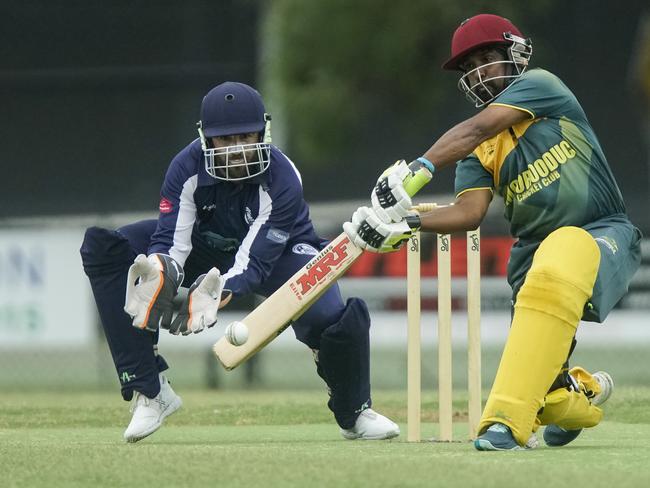 Moorooduc’s Rashimal Mendis cracks a cover drive as Pearcedale keeper Glenn Ferguson looks on. Picture: Valeriu Campan