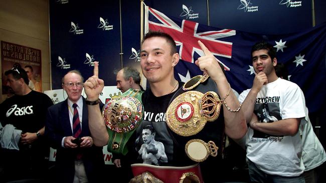 Kostya Tszyu with his titles in 2001.