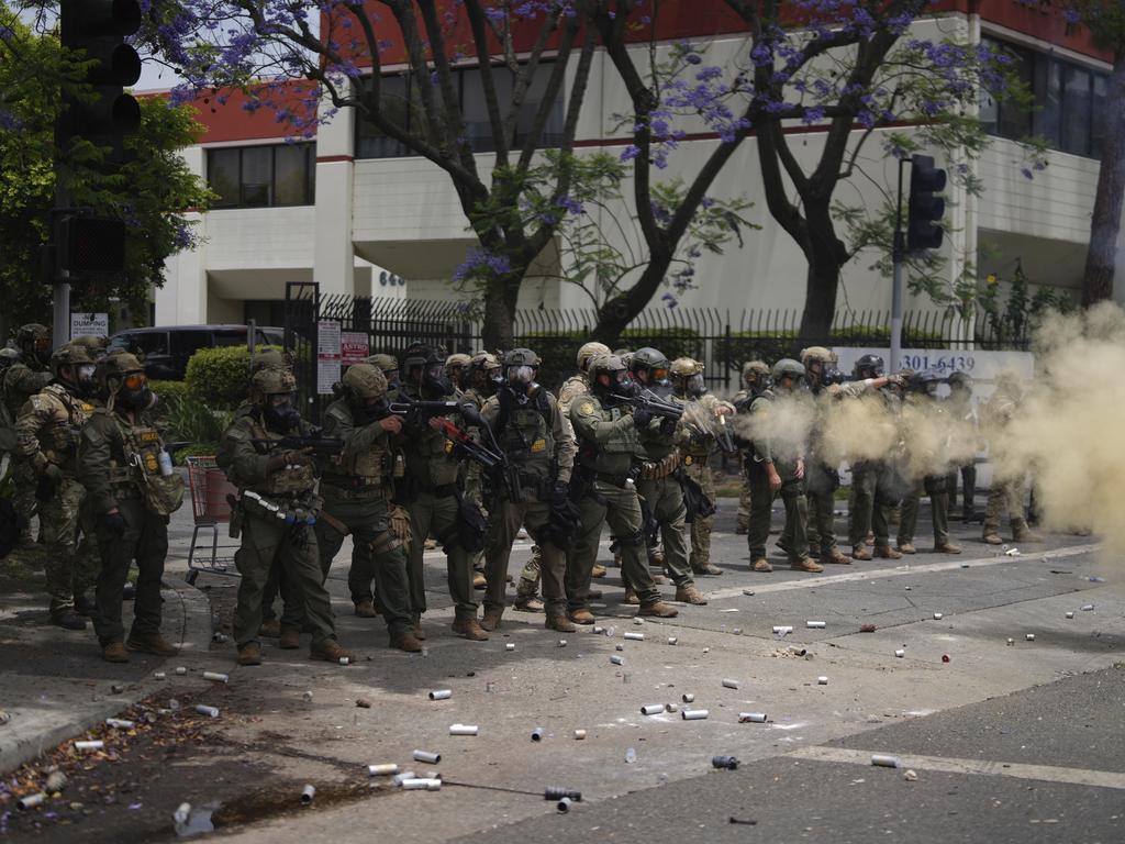 Border Patrol personnel deploy tear gas during a demonstration over the dozens detained in an operation by federal immigration authorities. Picture: AP