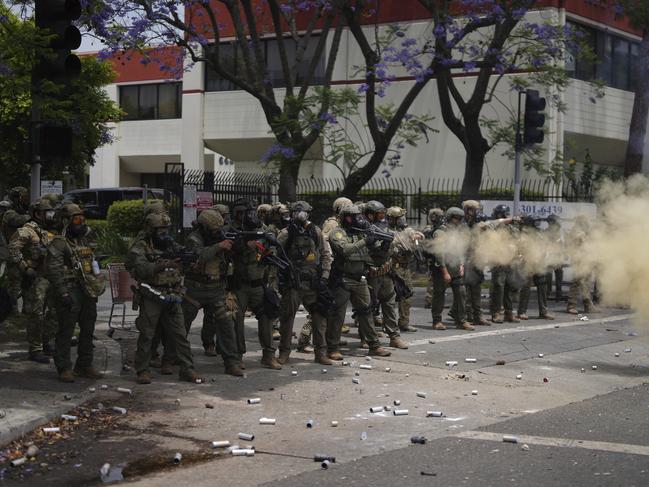 Border Patrol personnel deploy tear gas during a demonstration over the dozens detained in an operation by federal immigration authorities. Picture: AP