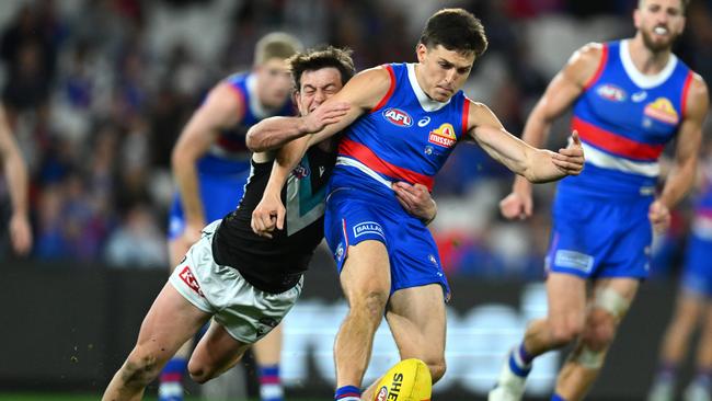 Laitham Vandermeer of the Bulldogs kicks whilst being tackled by Zak Butters. Picture: Quinn Rooney/Getty Images