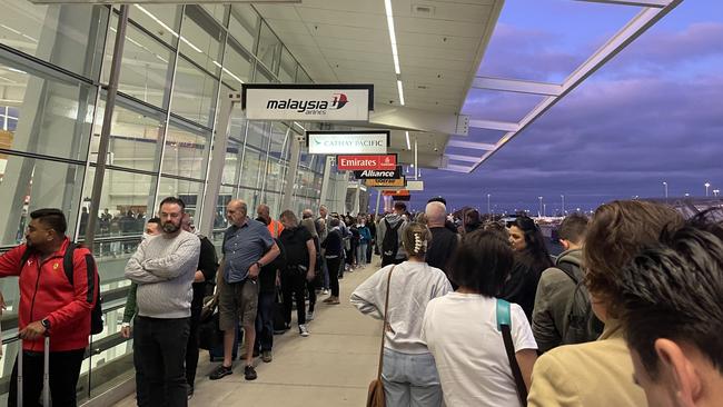 Long queues of passengers stretch outside Adelaide Airport terminal for the second time in a week. Picture: Doug Westley