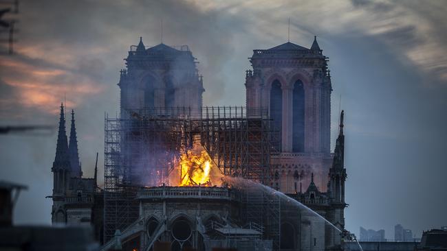 PARIS, FRANCE - APRIL 15: Smoke and flames rise from Notre-Dame Cathedral on April 15, 2019 in Paris, France. A fire broke out on Monday afternoon and quickly spread across the building, collapsing the spire. The cause is yet unknown but officials said it was possibly linked to ongoing renovation work. (Photo by Veronique de Viguerie/Getty Images)