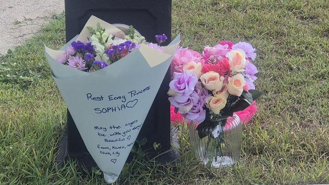Stuffed toys, flowers and messages from the community have begun to collect outside the suburban home on Regency Rd.