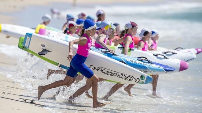 Competitors in action at the start of the under-11 Female Board quarter-final event at the NSW Surf Life Saving Championships at Blacksmiths Beach on Friday, 28 February, 2020. Picture: Troy Snook