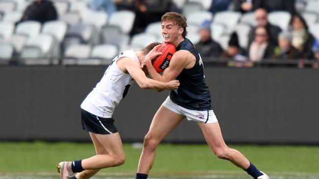 Paul Pascu of Vic Metro breaks a tackle during the U17 Championships match between Vic Country and Vic Metro at GMHBA Stadium on June 26, 2021. (Photo by Morgan Hancock/AFL Photos)