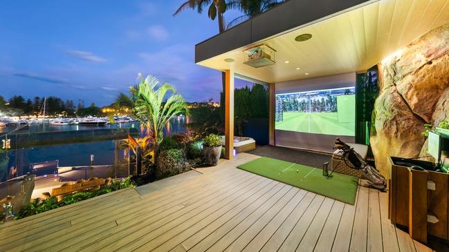 Outdoor golf simulator with Middle Harbour views.