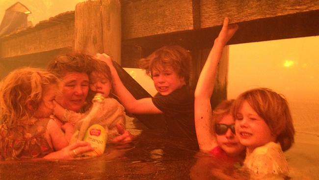 Tammy Holmes and her grandchildren during bushfires in Tasmania in 2013.