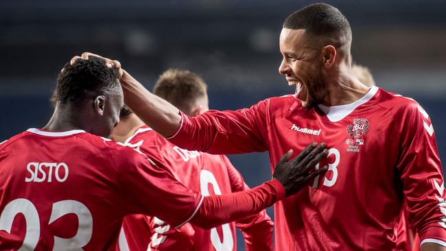 Denmark's Pione Sisto (left) celebrates with teammate Mathias Jorgensen.