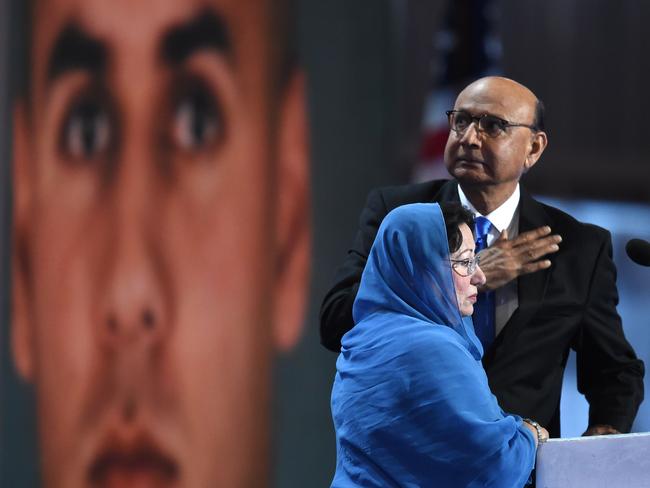 Khizr and Ghazala Khan appear on stage at the Democratic National Convention with a photo of their slain son Humayun S.M. Khan in the background. Picture: AFP/Timothy A Clary