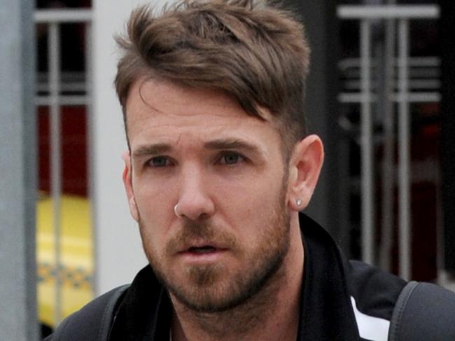 Dane Swan arrives back at Melbourne Airport after suffering a fractured fibula and foot in Collingwood's loss to Sydney yesterday. Picture: Andrew Henshaw