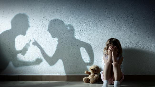 istock generic: woman, abuse, DV, domestic violence, harassment, sexual harassment. Little Girl Crying With Shadow Of Parents Arguing – Home Violence And Divorce. Picture: istock