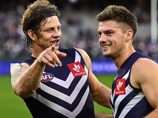 PERTH, AUSTRALIA - JUNE 11: Nat Fyfe and Ethan Hughes of the Dockers are happy with the win during the 2022 AFL Round 13 match between the Fremantle Dockers and the Hawthorn Hawks at Optus Stadium on June 11, 2022 in Perth, Australia. (Photo by Daniel Carson/AFL Photos via Getty Images)