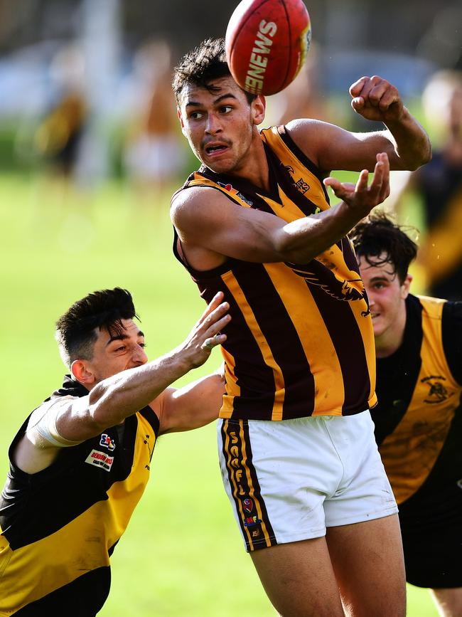 Modbury’s Daniel Kaipara gets a handball away against Broadview. The Hawks will be relegated from division two. Picture: AAP/Mark Brake