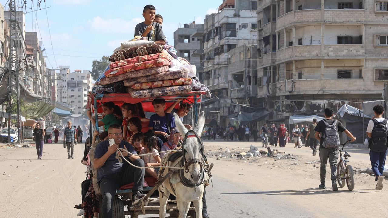 Palestinians transport their belongings as they flee areas north of Gaza City in the northern Gaza Strip on October 12, 2024. Picture: AFP.