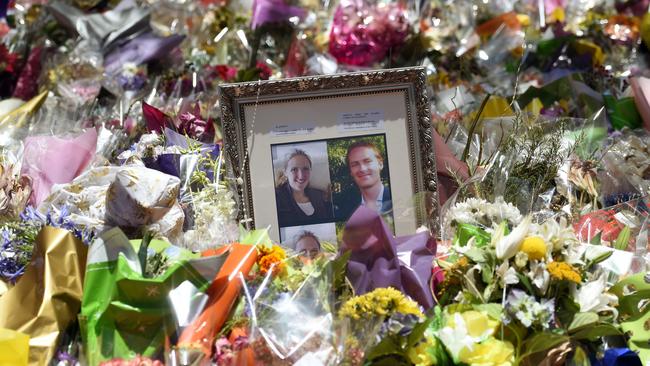 Photos of Katrina Dawson (L) and Tori Johnson (R) sit amongst the numerous floral tributes left outside the Lindt cafe in Sydney's Martin Place. (Pic: AFP/William West)