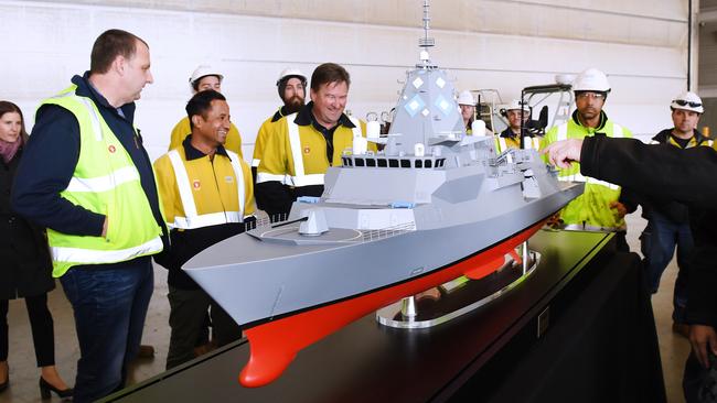 ASC workers get their first look at a model of the Hunter Class Frigate before a visit from then Prime Minister Malcolm Turnbull in 2018. The defence sector offers a wealth of opportunities for people to build rewarding career paths. Picture: AAP/Mark Brake