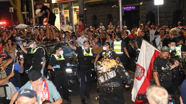 A man jumped on the car as the crowd surged. Picture: AFP