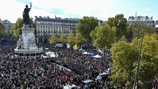 People gather on Place de la Republique in homage to history teacher Samuel Paty.