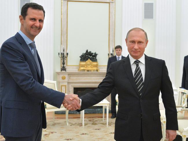 Russian President Vladimir Putin shakes hand with Syrian President Bashar Assad. Picture: Sputnik, Kremlin Pool Photo via AP