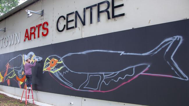 Jyi Westaway painting his honeybird mural on the Bankstown Arts Centre’s Imagine Wall.