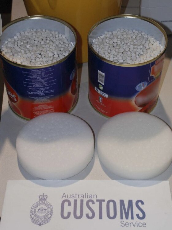 Tins disguised as canned tomatoes hold thousands of ecstasy tablets. Picture: Australia Customs Service