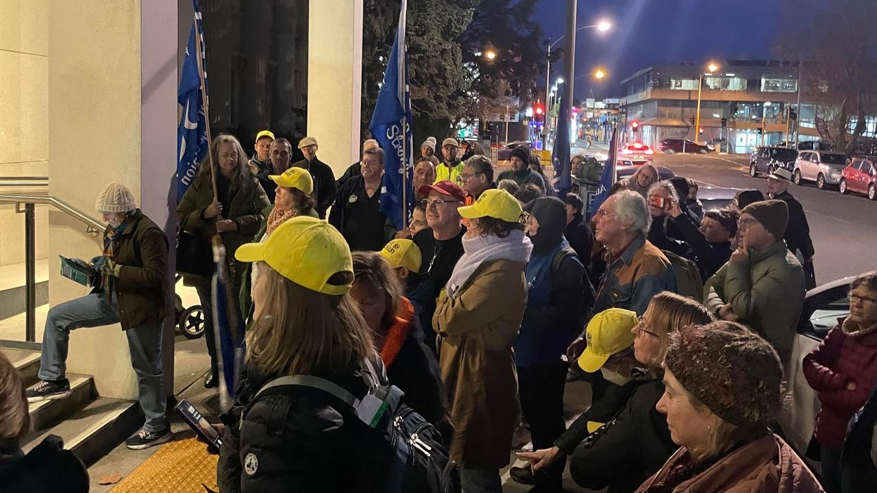 Protesters rallying outside City of Greater Geelong Council chambers before the meeting. Members of the Save Barwon Heads Library group in yellow hats.