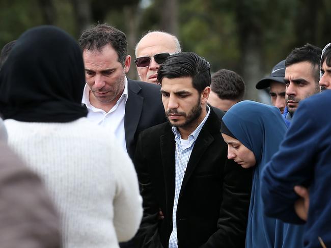 Jihad Dib (centre left) comforts his brother, champion boxer Billy Dib (centre right) at his wife Sara Selim Dib's grave.