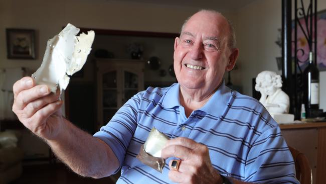 Ted holding pieces of the Oxley Airlines plane he crashed in at Port Macquarie in 1985. Picture Glenn Hampson