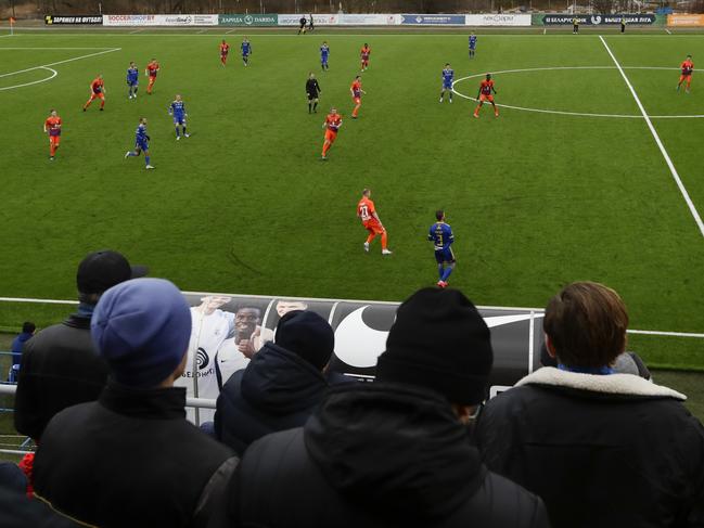 In this photo taken on Thursday, March 19, 2020, football fans watch the Belarus Championship soccer match between Energetik-BGU and Bate in Minsk, Belarus.  Almost all of Europe has suspended soccer games amid the coronavirus pandemic, but Belarus is just getting started as officials insist they're not starting the season just to suspend it later. Unlike most of Europe, it runs on a calendar-year format, playing from March through December to avoid the snow-bound winter.  For some people the new COVID-19 coronavirus causes only mild or moderate symptoms, but for some it can cause severe illness.  (AP Photo/Sergei Grits)