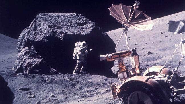 Scientist and astronaut Harrison H Schmitt works beside a huge boulder during the Apollo 17 moon landing in December 1972. Picture: AP