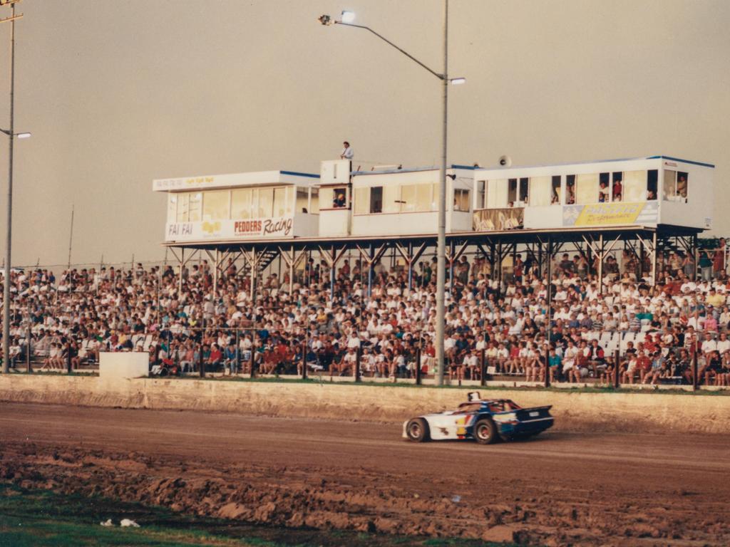 Car racing past the crowd at the Archerfield Speedway – Photo Supplied Brisbane John Oxley Library, State Library of Queensland