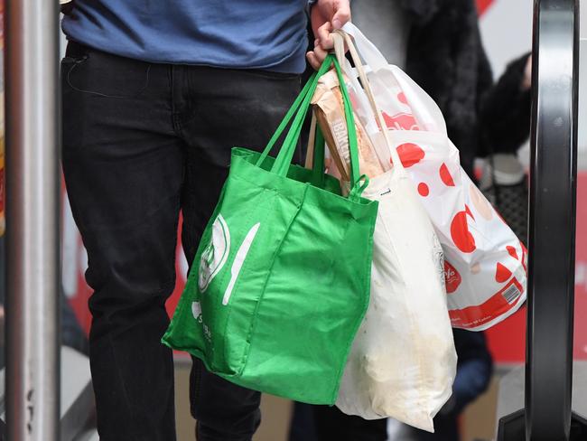 A shopper is seen carrying bags at a Coles Sydney CBD store, Sydney, Monday, July 2, 2018. Woolworths says it will hand out free reusable bags for the next 10 days as its customers get used to its ban on single-use plastic bags. Woolies stores in NSW, Queensland, Victoria and Western Australia stopped providing free single-use plastic bags on June 20. (AAP Image/Peter RAE) NO ARCHIVING