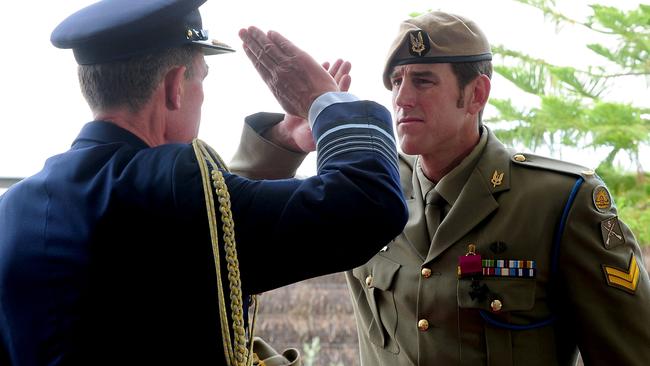 Corporal Roberts-Smith salutes after receiving his Victoria Cross medal in 2011. Picture: Department of Defence