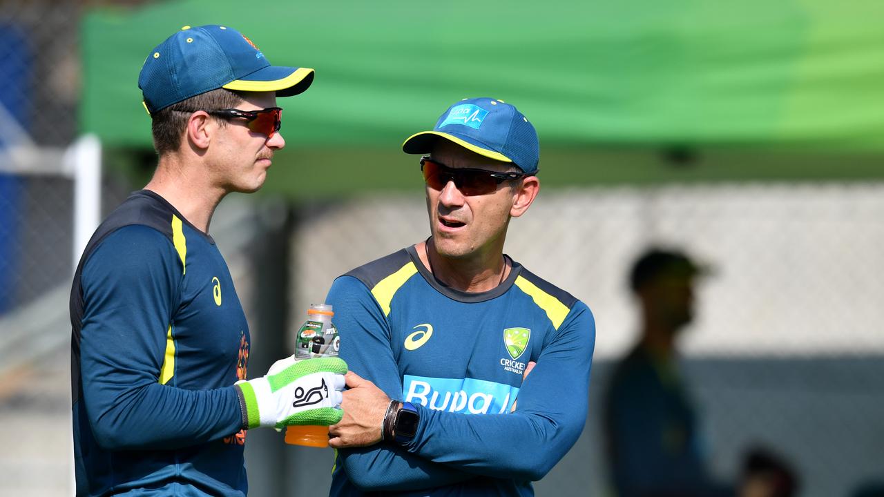 Tim Paine (left) and Australian coach Justin Langer (right) are seen during the Australian Men's cricket team training session at the Gabba in Brisbane, Tuesday, November 19, 2019. Australia will take on Pakistan in the first test at the Gabba from Thursday. (AAP Image/Darren England) NO ARCHIVING