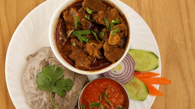 Dhedo with goat curry at AD’s Kitchen, a Nepalese restaurant in Campsie. Picture: Jonathan Ng