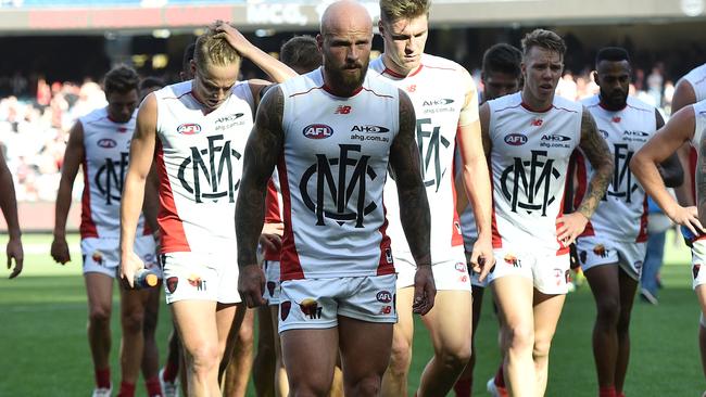 Melbourne Demons captain Nathan Jones (centre) led his team from the ground after being defeated by the Essendon Bombers in round two of the AFL at the MCG in Melbourne, Saturday, April 2, 2016. (AAP Image/Julian Smith) NO ARCHIVING, EDITORIAL USE ONLY
