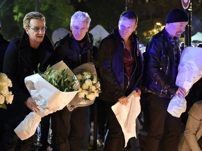 Tours cancelled ... Irish band U2 (from left) lead singer Bono, bass player Adam Clayton, drummer Larry Mullen Jr and guitarist The Edge pay homage to the Paris victims near the Bataclan concert hall.