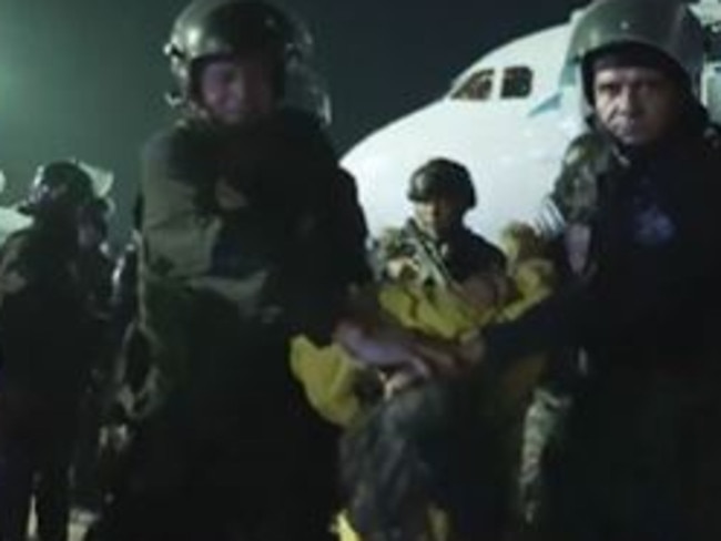 US forces hold a prisoner’s head down as they disembark him from a deportation flight. Picture: The White House