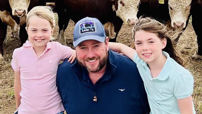 Ben Davies, of Wild Bear Herefords, with daughters Emma and Elle on their property at Meadows, in the Adelaide Hills.