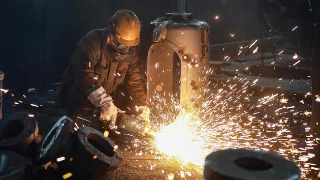 An employee works on steel casting at a factory in Hangzhou, China. Picture: AFP