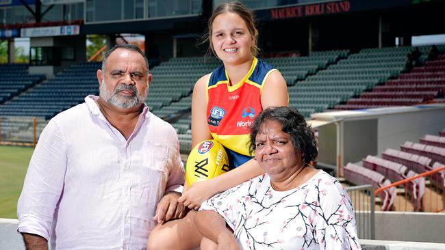 Danielle Ponter who has been drafted into the Adelaide Crow's AFLW team with Michael Long and mum Susie Long at TIO Stadium.