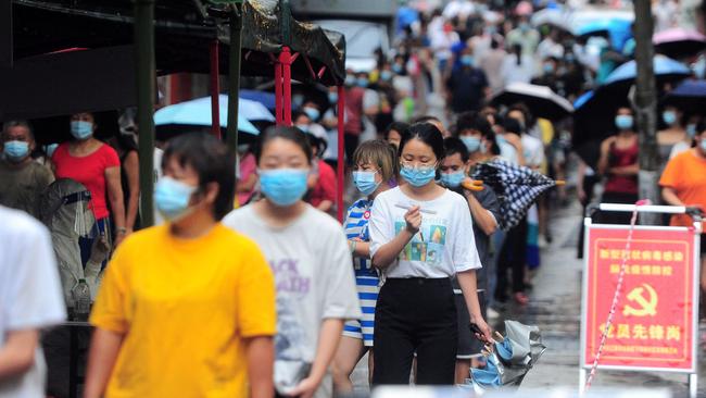 Residents and tourists queue to undergo tests for Covid-19 in Sanya in China's southern Hainan province. Picture: AFP