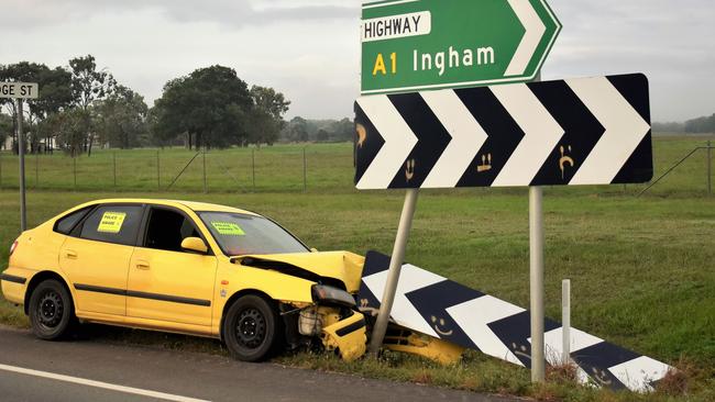 The wreck of a bright yellow Hyandai hatchback car pictured  on the Bruce Highway on Sunday morning after it collided with a traffic sign south of Ingham on Friday evening. Picture: Cameron Bates