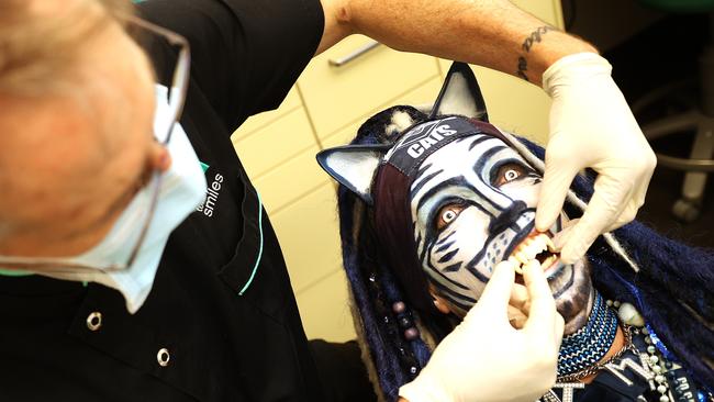 "Catman" Troy West from the Geelong footy cheer squad is fitted for his new fangs Totally Smiles Dr Simon McPherson. Picture: Alison Wynd