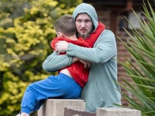 Neighbour Jarrod Hawkins - pictured hugging his son - has been hailed a hero. Picture: NewsWire / Simon Bullard.